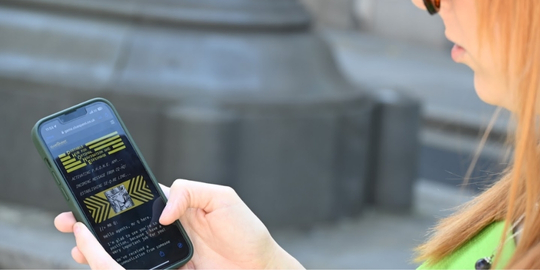 Player using phone as a spy gadget to solve puzzles on the streets of London